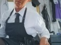22nd July 2019 -  shirt and black cotton tie with black PVC skirt under a black cotton full length hairdressing  apron
